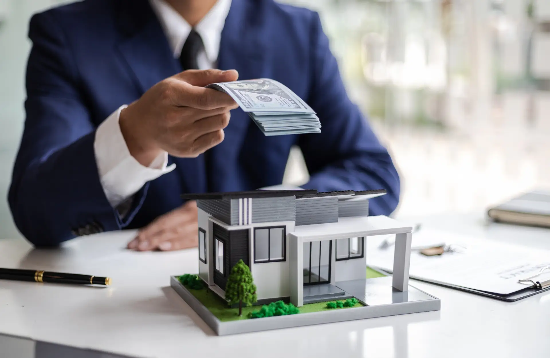 real estate businessman giving money for buying a house